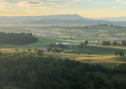 Scenic view of Shenandoah Valley from On Sunny Slope Farm, showcasing rolling hills, lush greenery, and distant mountains, ideal for weddings and outdoor gatherings.