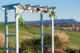 Wedding arch adorned with flowers, set against a scenic Shenandoah Valley landscape, ideal for outdoor ceremonies at On Sunny Slope Farm.